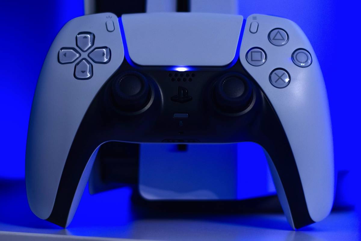 gaming accessory ps4 how to connect – DualShock 4 controller plugged into PS4 console via USB cable for initial pairing