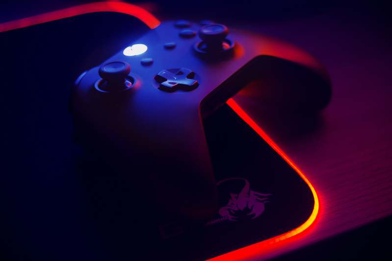 Stack of reviewed PS4 controllers in various colors and custom designs